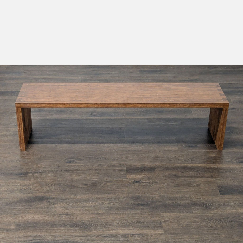 2. Top-down view of a minimalist rectangular wooden bench with sturdy legs and smooth surface on wood flooring.