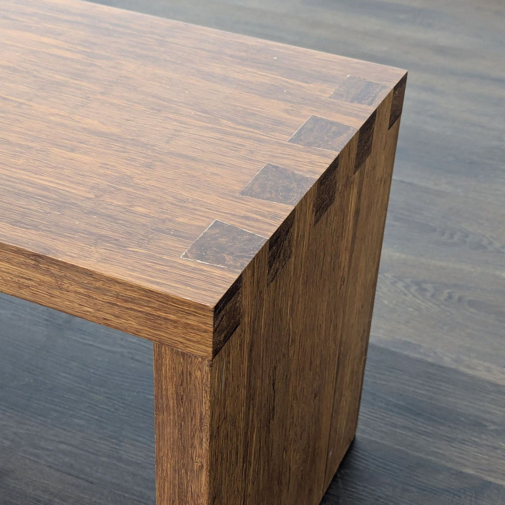3. Close-up of the wooden bench's corner, highlighting dovetail joints and wood grain for the Stools & Benches category.