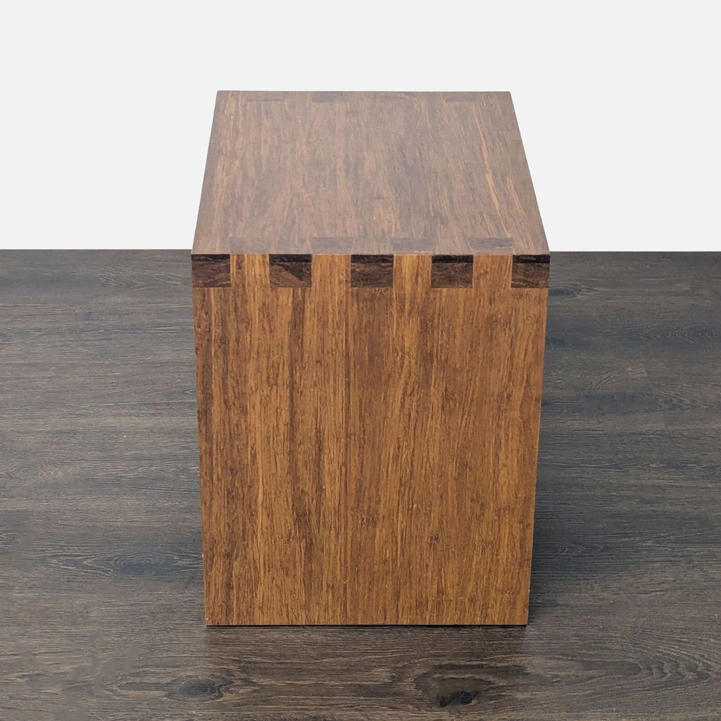2. Side view of a wooden end table highlighting dove-tail joinery and natural wood grain pattern.