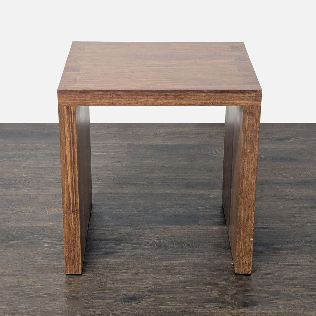 3. Modern square wooden end table with clean lines and open sides, placed on a dark wood floor.