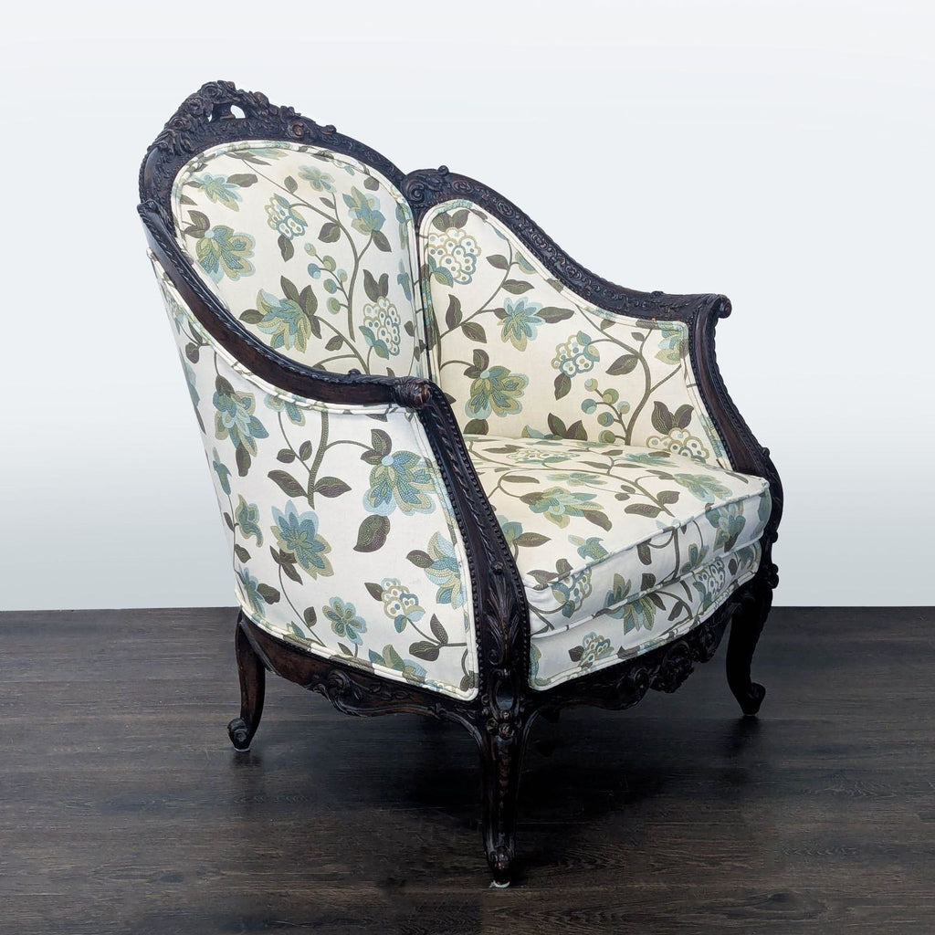 Classic lounge chair featuring ornate wood details and soft floral upholstery in subtle blue and green tones.