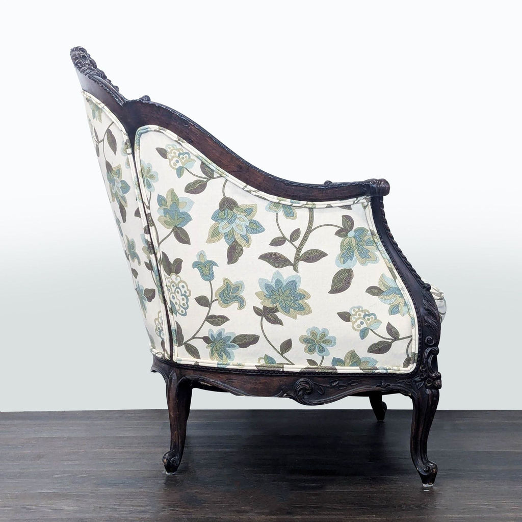 Floral upholstered lounge chair with sturdy carved wood frame in dark finish.