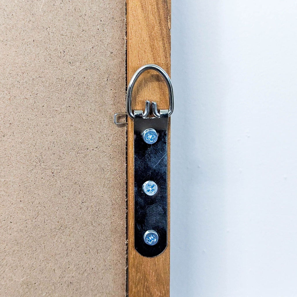 3. Close-up of metal hanging hardware securely fastened to the wooden frame at the rear of the mirror.
