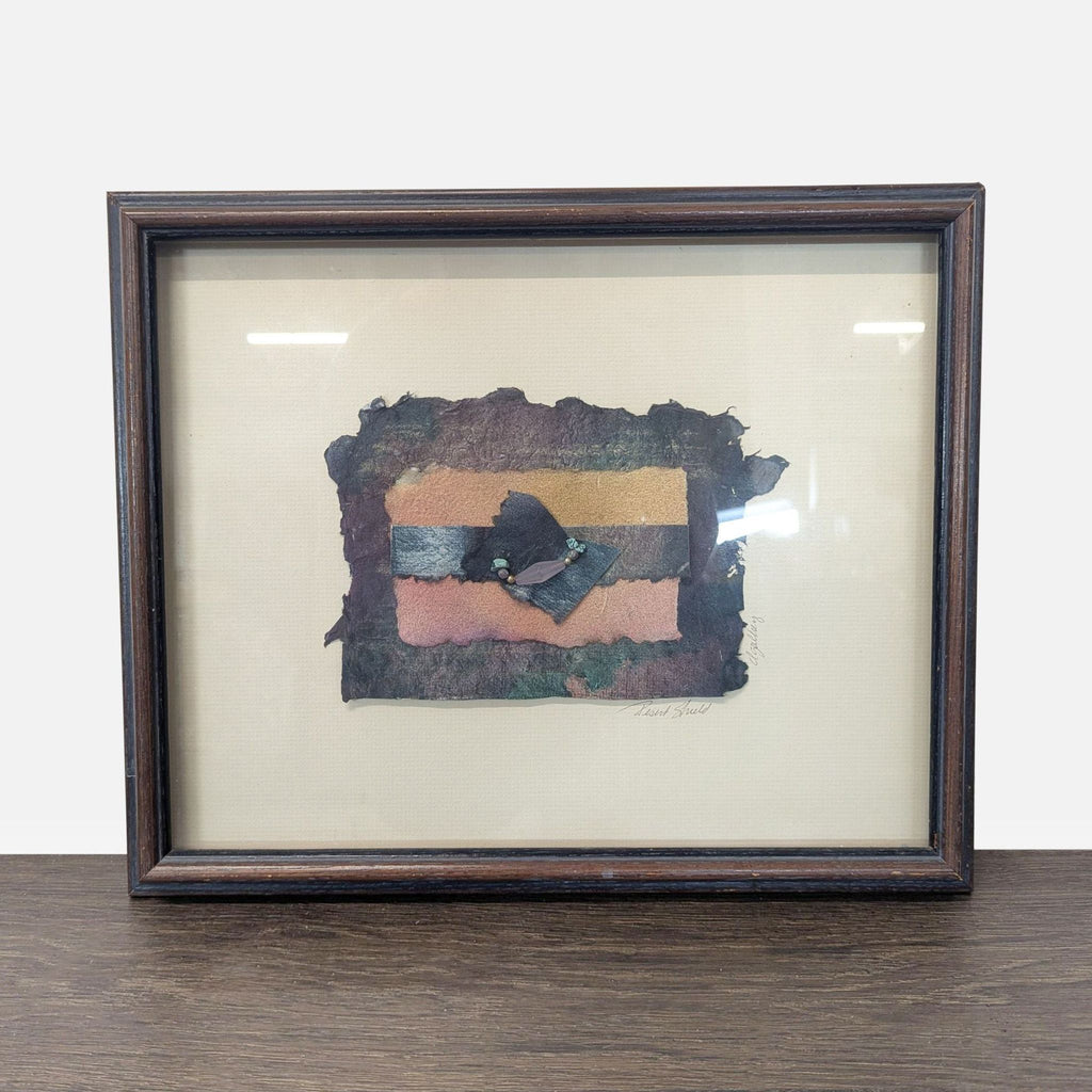 1. Framed abstract artwork with handmade paper, colorful stripes, and decorative beads, set on a cream mat.  