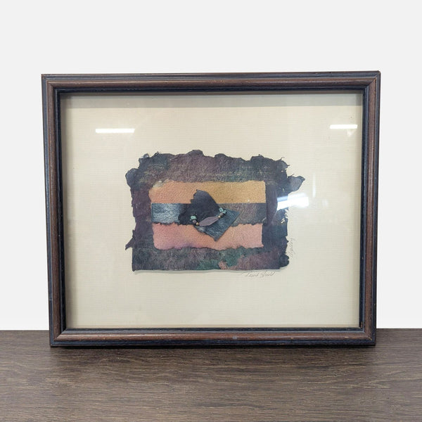 1. Framed abstract artwork with handmade paper, colorful stripes, and decorative beads, set on a cream mat.  