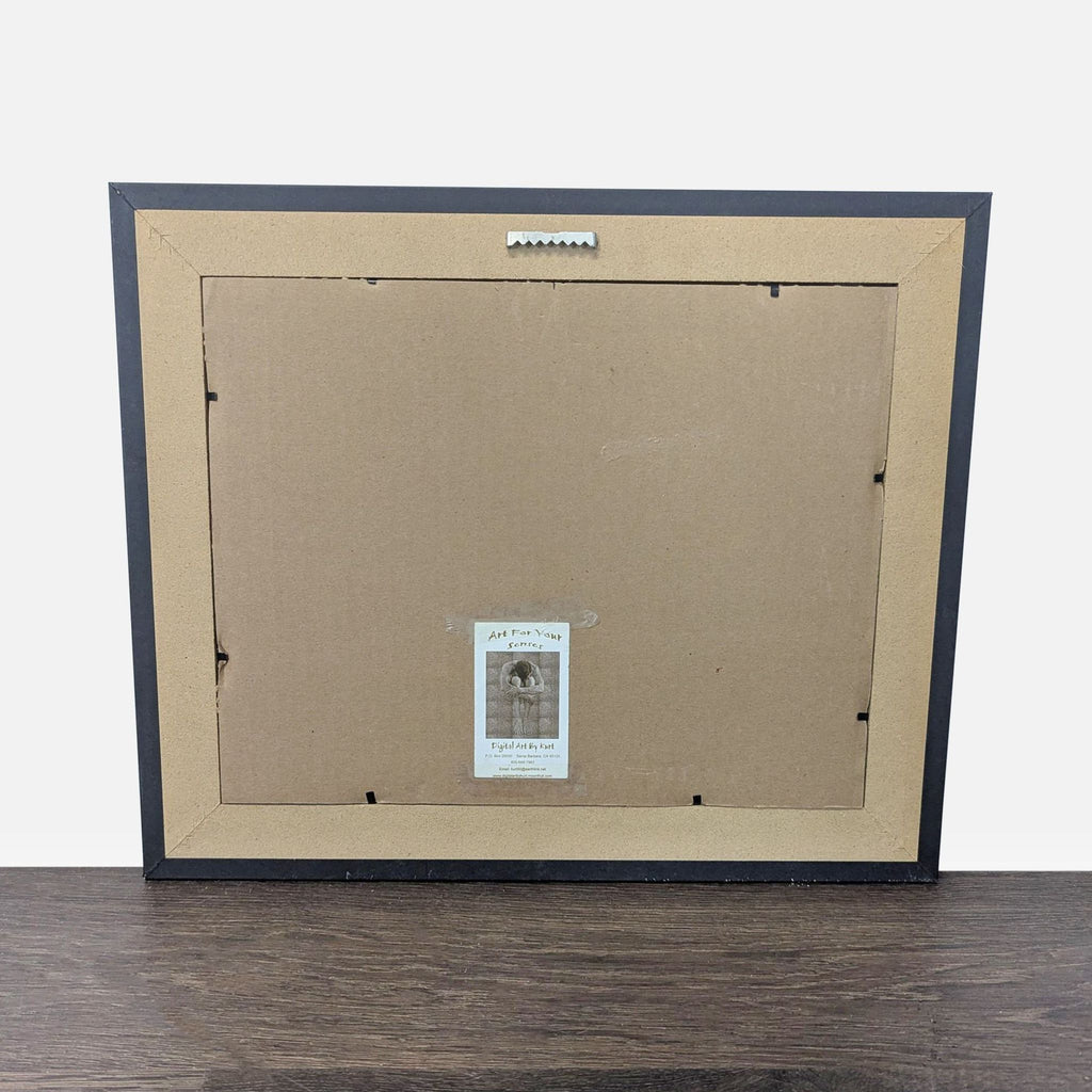 3. Back view of the framed artwork, featuring a hanging hook and label, showing it is ready for display.