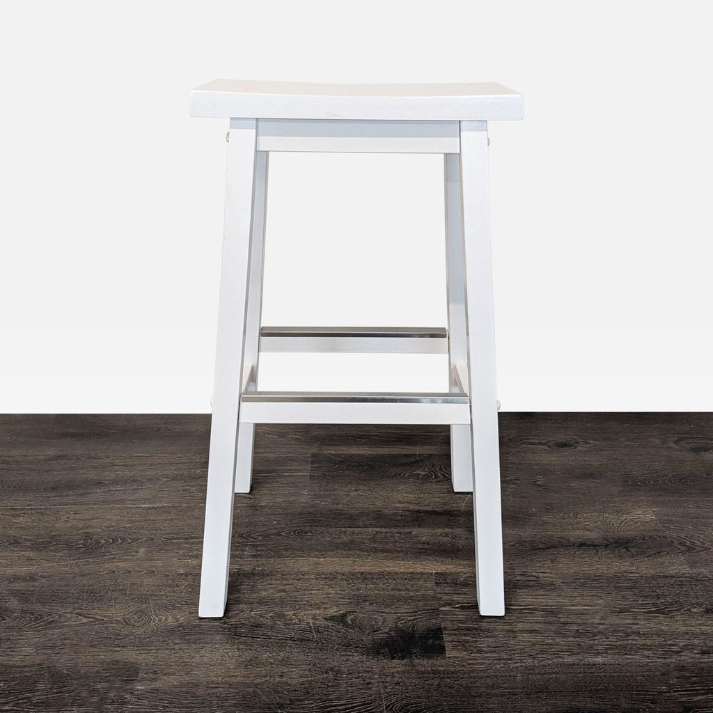Sleek metal footrest with a minimalist rectangular design, suitable for modern settings.  