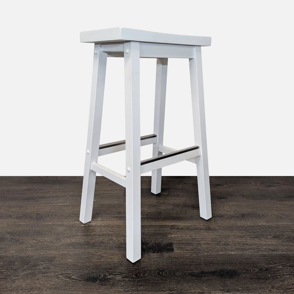 Contemporary metal stool serving as a footrest, ideal for pairing with benches or ottomans.  