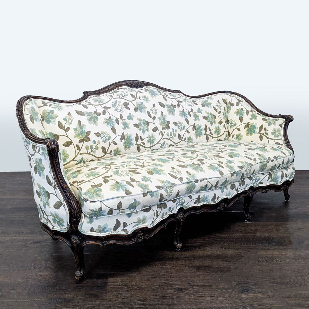 Elegant 3-seat sofa with floral upholstery in green and blue, featuring a scalloped wood frame and classic design.  