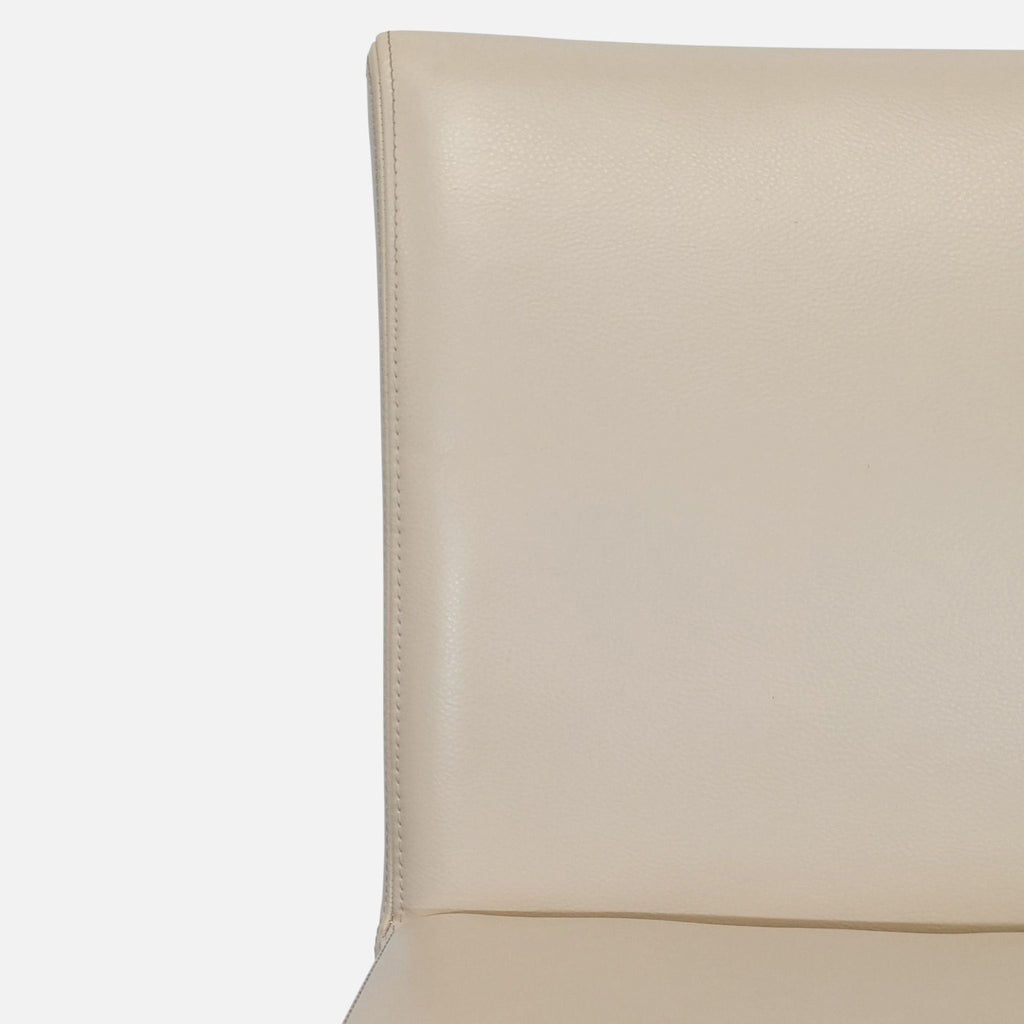 2. Modern ivory leather chair by Crate & Barrel featuring sleek ebony-stained wooden legs.  