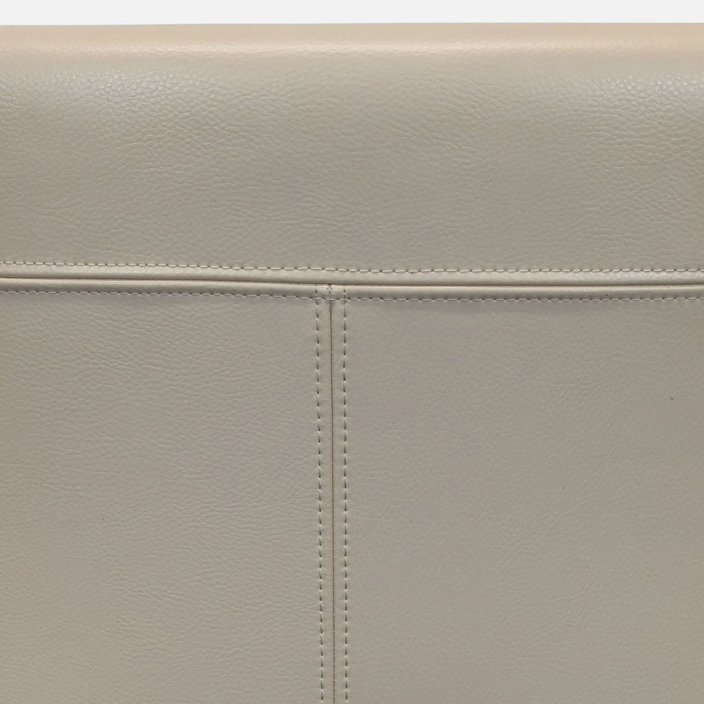 3. Crate & Barrel armchair, cushioned ivory leather upholstery, and solid ebony-finished wood legs.