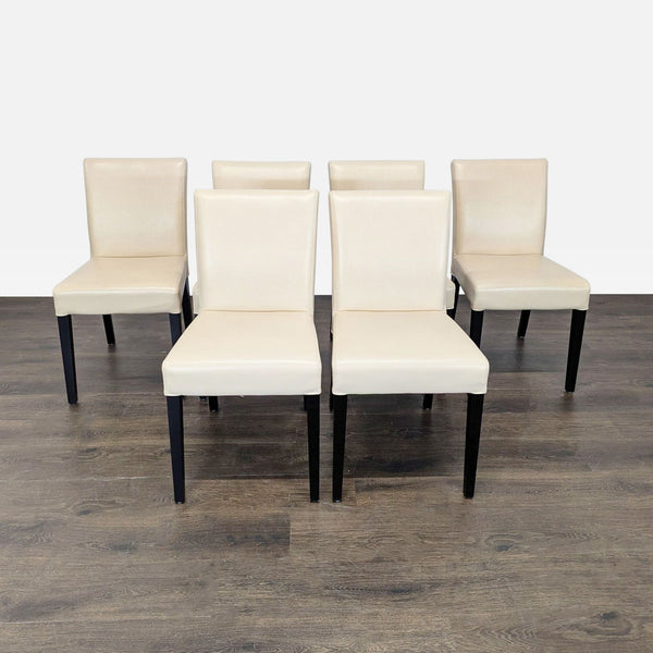 1. Crate & Barrel accent chair in ivory riverstone leather with dark ebony wood legs, contemporary style.  