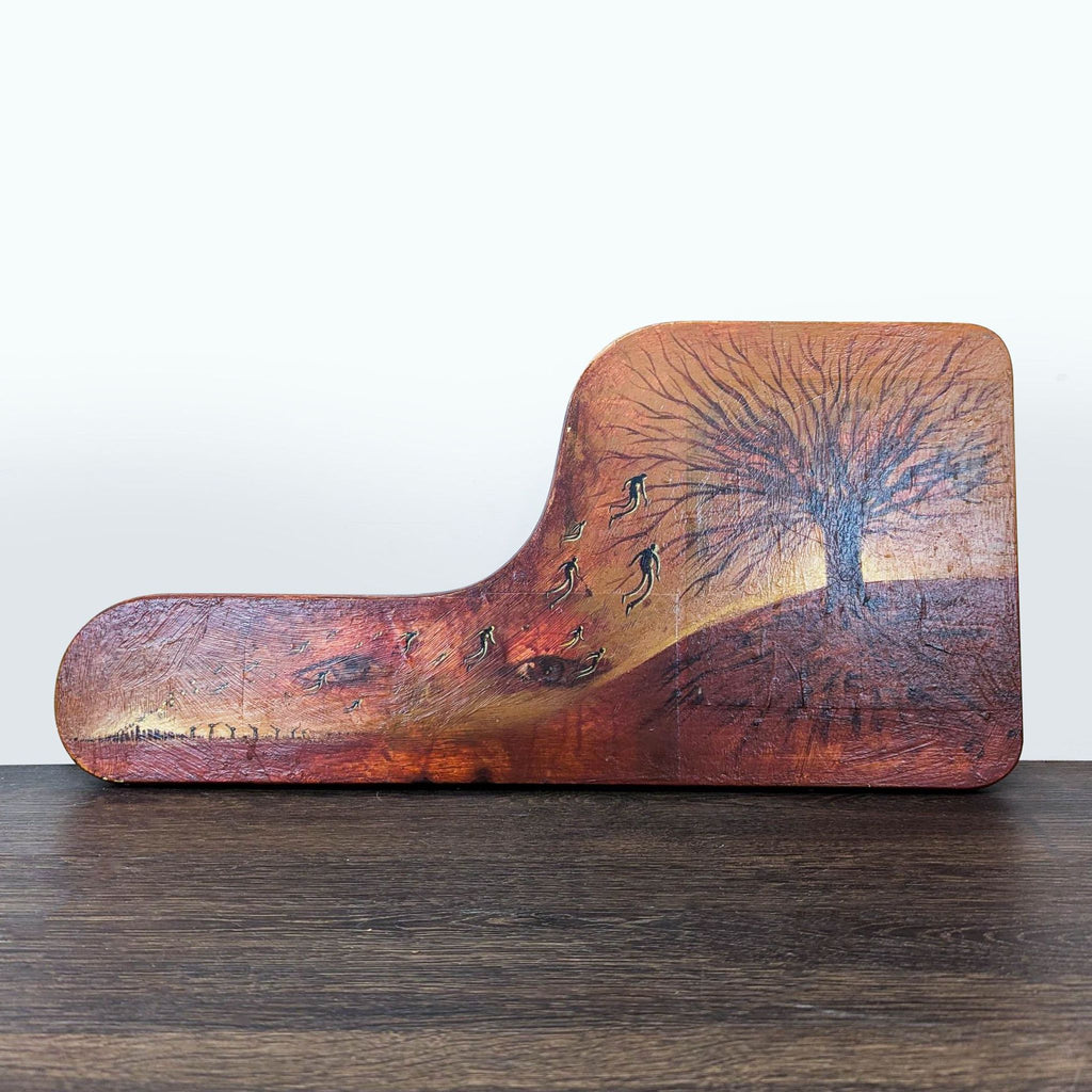 1. Artwork on shaped wood shows a dark tree, floating figures, and hidden eyes on a sunset landscape.