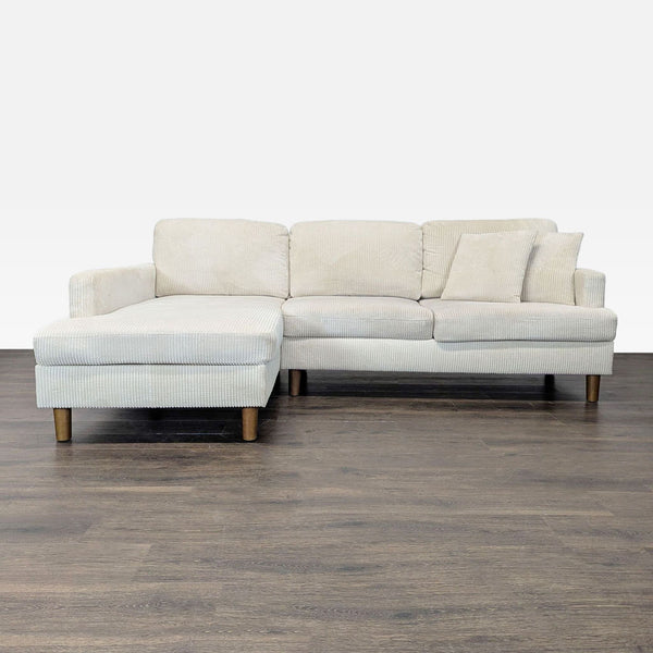 Light beige corduroy sectional with chaise, wooden legs, and cozy cushions, perfect for modern living rooms.