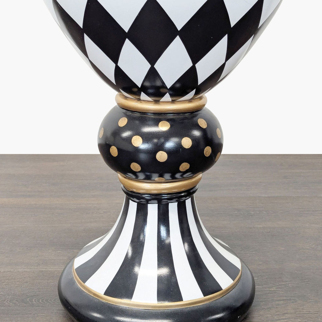 Bold vase featuring hand-painted stripes, dots, and gold details by MacKenzie-Childs, set on a pedestal.