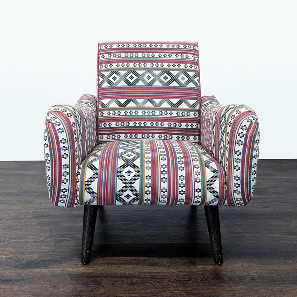 1. Front view of a Cost Plus lounge chair with vibrant, multi-color patterned fabric and sturdy wooden legs.