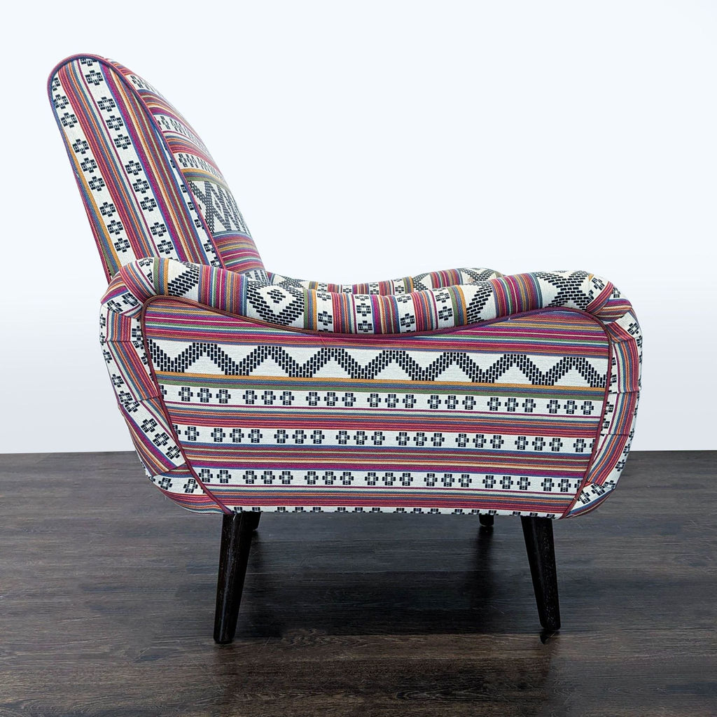 3. Side profile of lounge chair by Cost Plus, highlighting its colorful patterned fabric and comfortable armrest design.