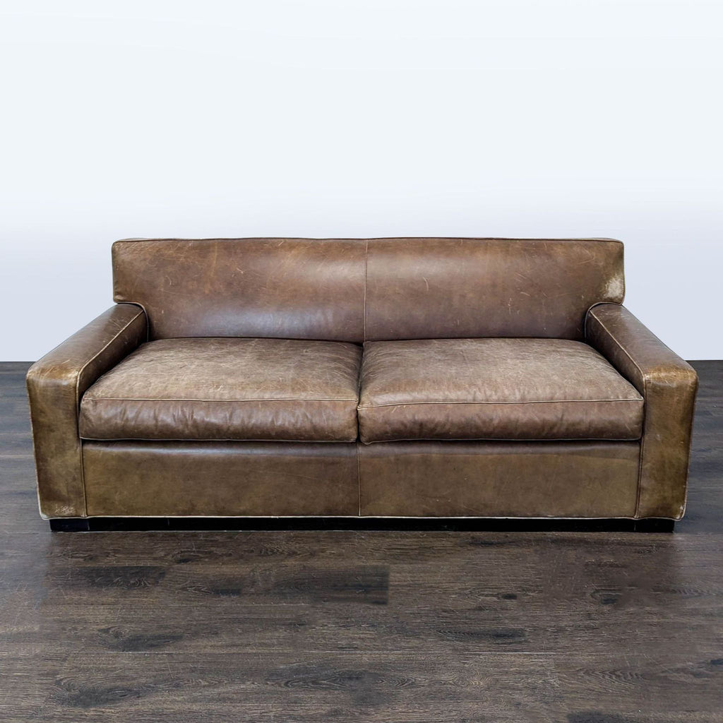 Mitchell Gold 3-seat brown leather sofa with wide arms, classic style, and visible vintage wear.