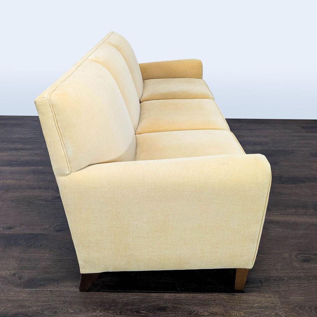 Three-seat Room and Board sofa in light beige fabric, contemporary design with wooden legs, well maintained.