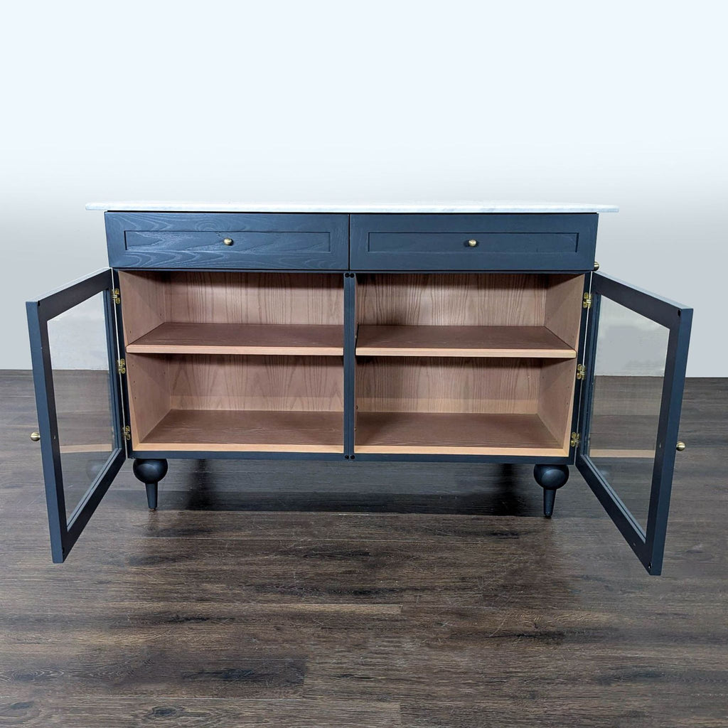 Marble-topped kitchen island by Anthropologie, featuring spacious drawers and glass cabinets for storage.  