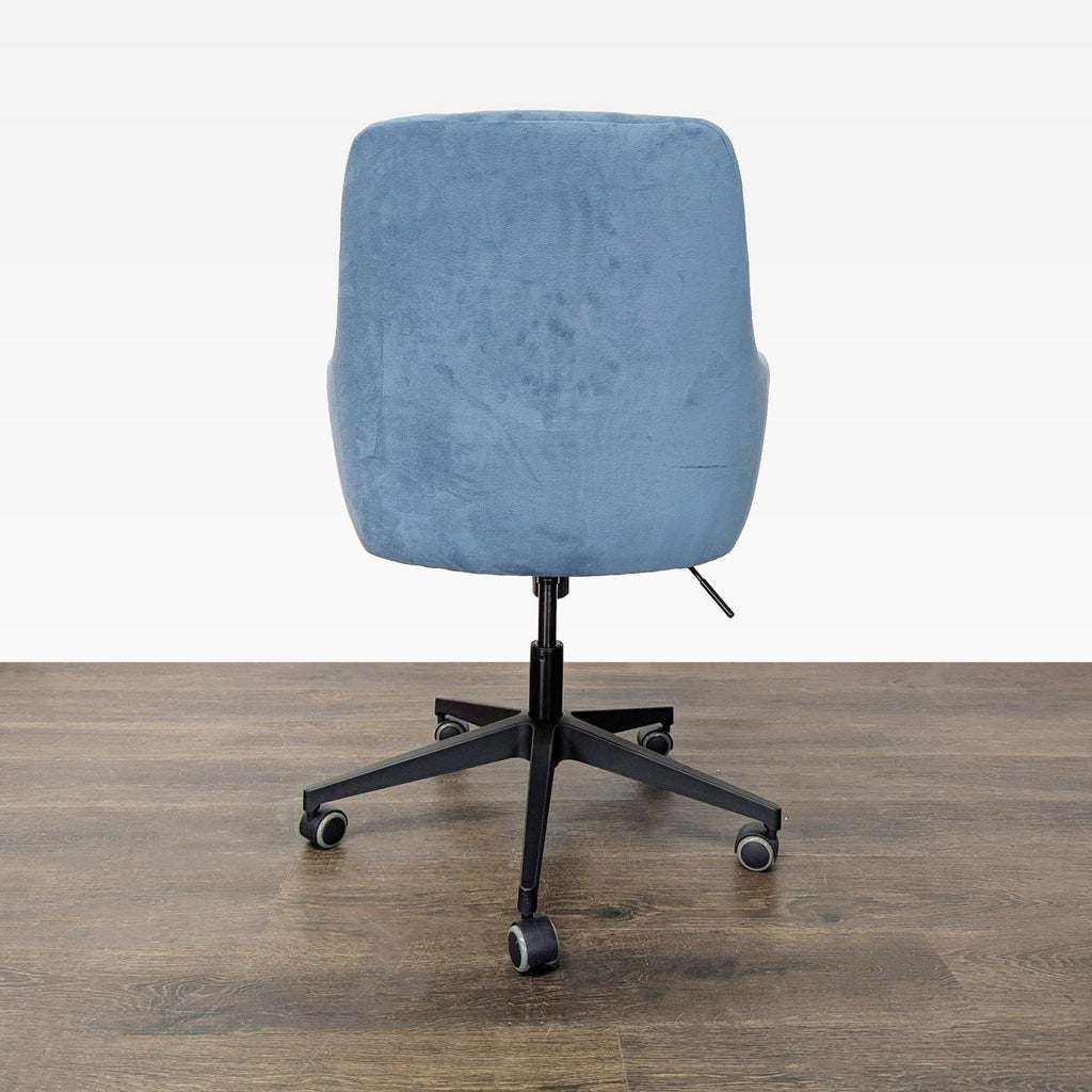 Stylish blue Skyline Furniture chair with comfortable armrests, sturdy black base, and easy-glide casters.