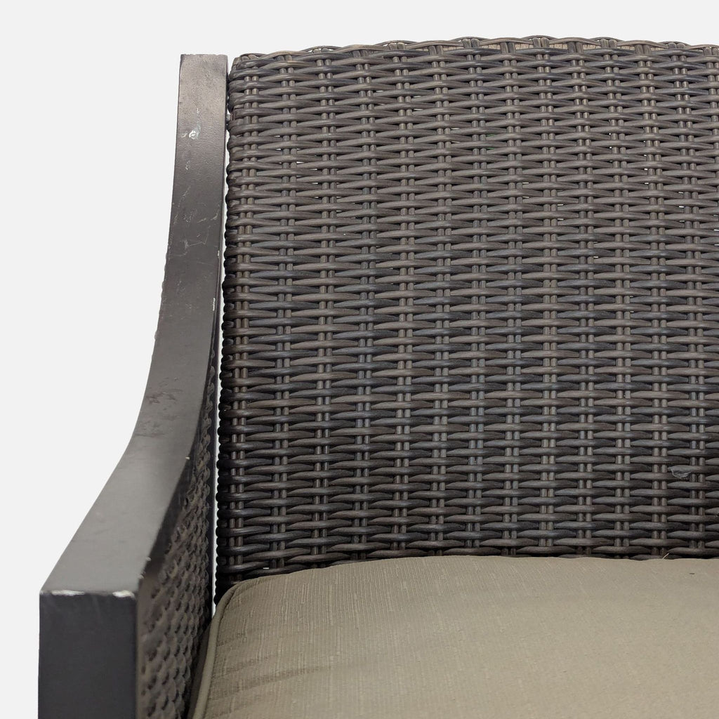3. Close-up of the chair's woven rattan backrest, armrest, and beige cushion detailing, showing material texture.
