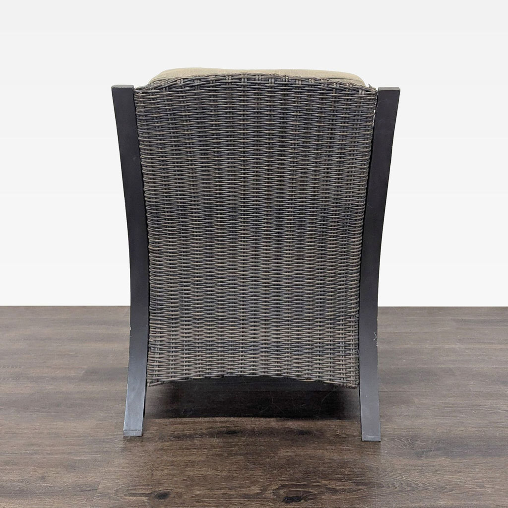 Back view of a wicker and metal armchair designed for durability and comfort in patio or indoor spaces.