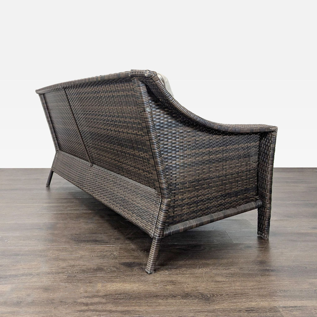 Back view of a Threshold 3-seater sofa in woven brown wicker, highlighting its sturdy and stylish outdoor design.
