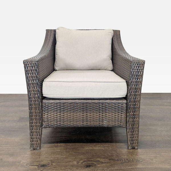 Threshold armchair with brown wicker frame and beige cushions, suitable for indoor or outdoor use.