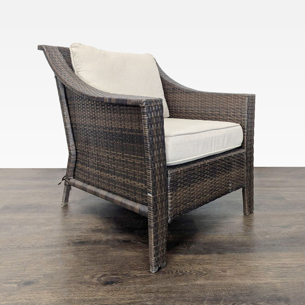 Wide-seat wicker armchair with beige padding, supportive arms, and neutral tones for versatile decor.