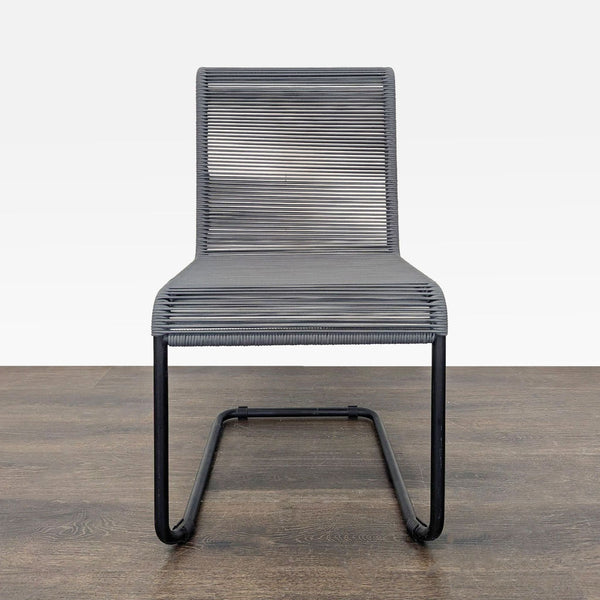 Modern black metal chair with woven seat and back, perfect for dining or office spaces, minimalist and durable.