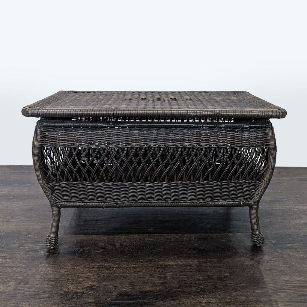 Rectangular all-weather wicker coffee table with a dark brown finish and curved legs, suitable for indoor or outdoor use.