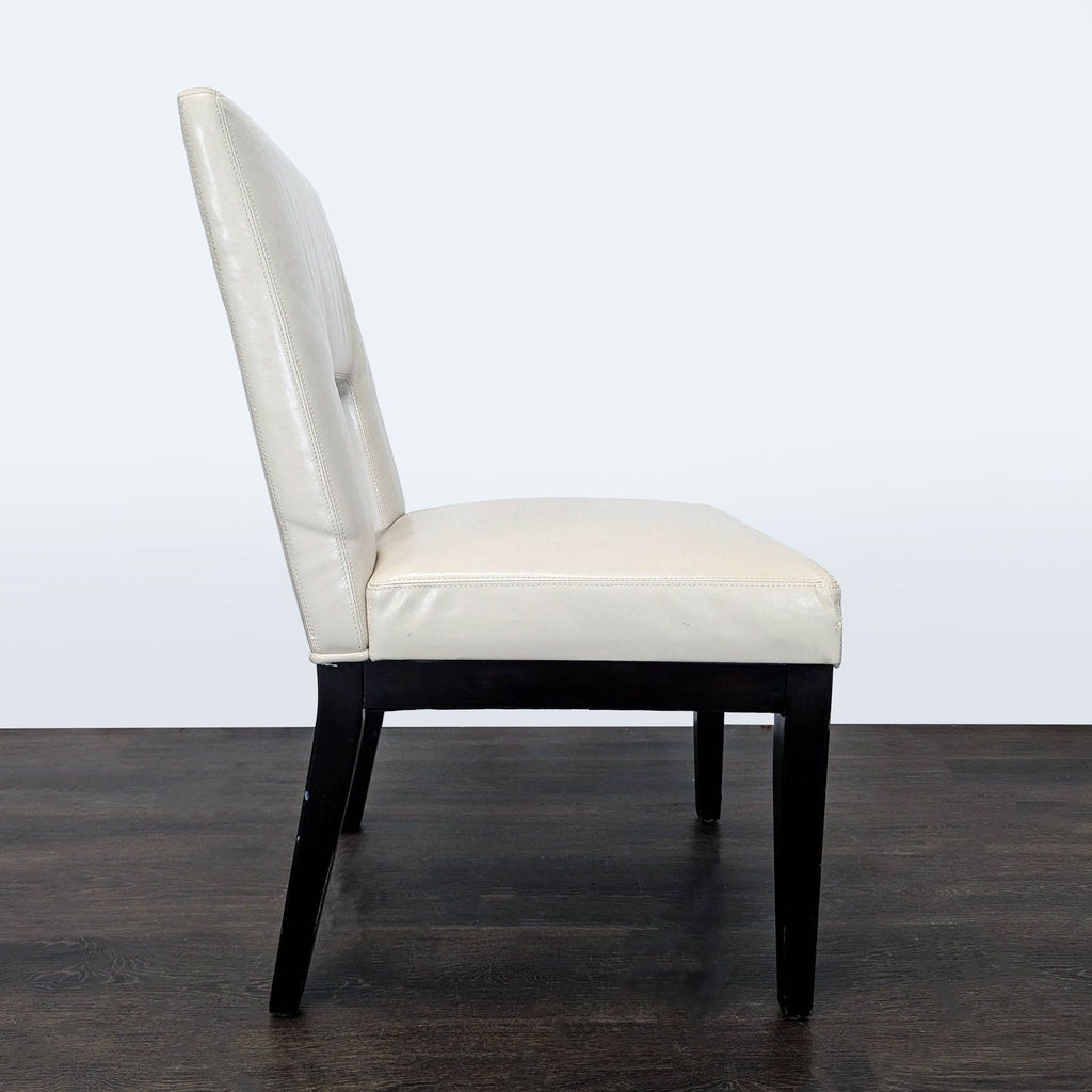 3. Side profile of a Pier 1 Imports dining chair featuring ivory upholstery and a unique cutout back design.