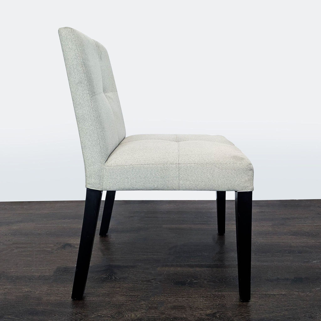 Elegant Crate & Barrel dining chair; wood base, tufted seat back, low profile—perfect as dining seating.