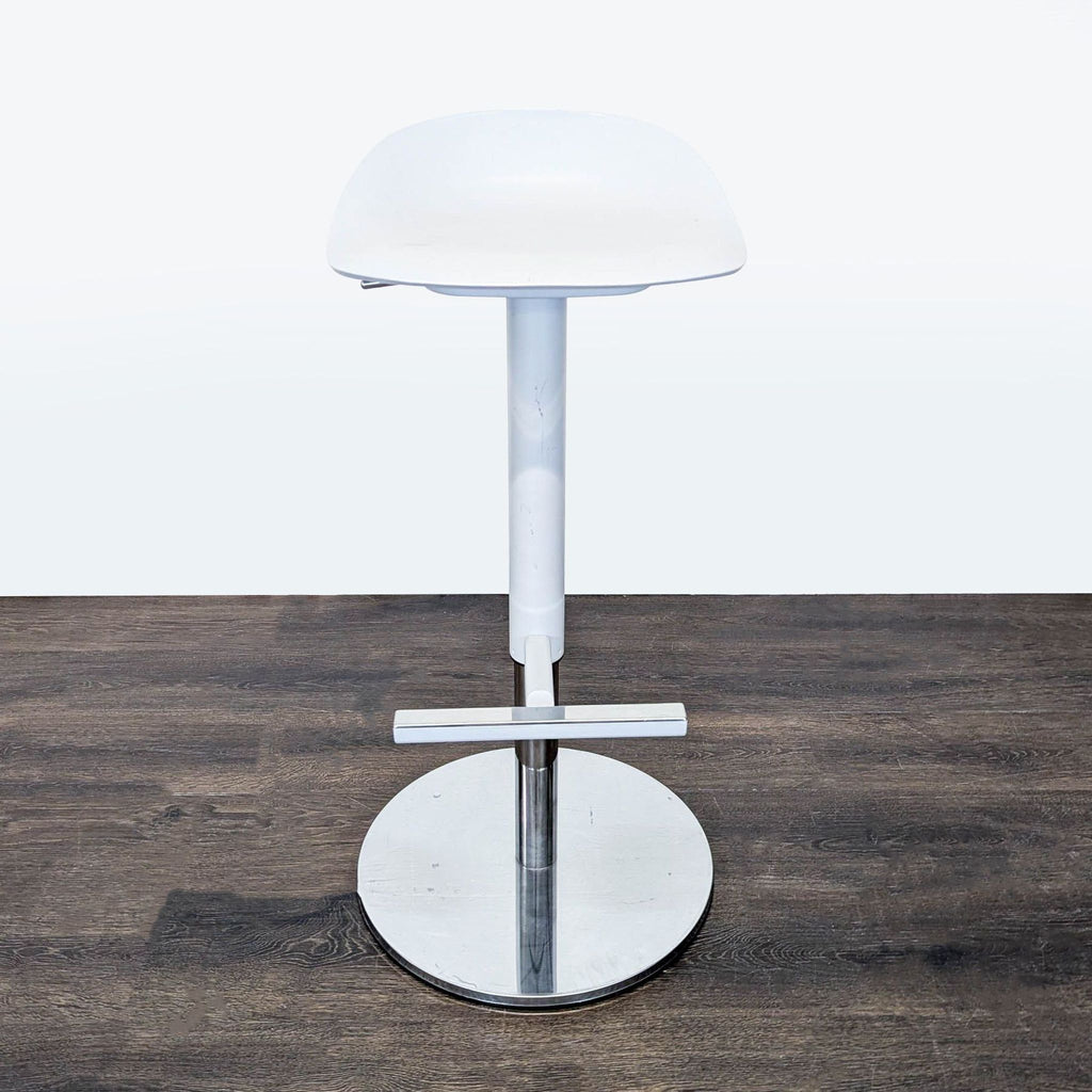 Ikea adjustable stool with scooped seat, footrest, and scratch-resistant finish, designed by a team of five.