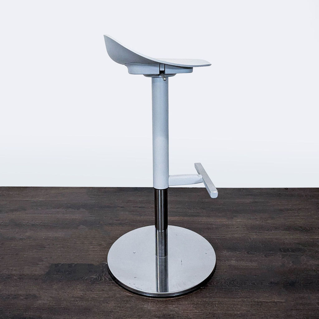 Modern Ikea stool featuring a contoured seat, single-handed height adjustment, and a circular footrest.