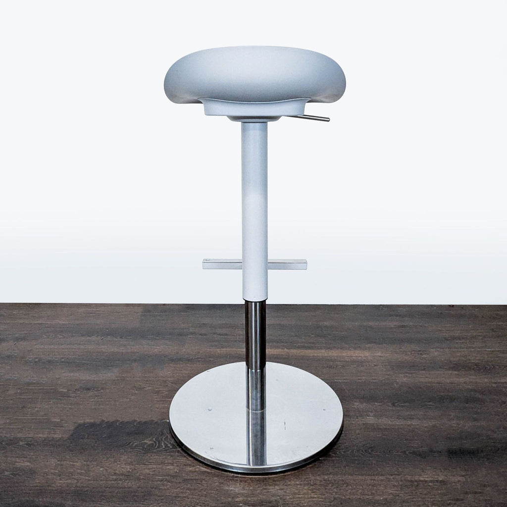 Scooped-seat Ikea stool by John/Jonas/Petrus/Paul/Caroline; height adjustable and scratch resistant with footrest.