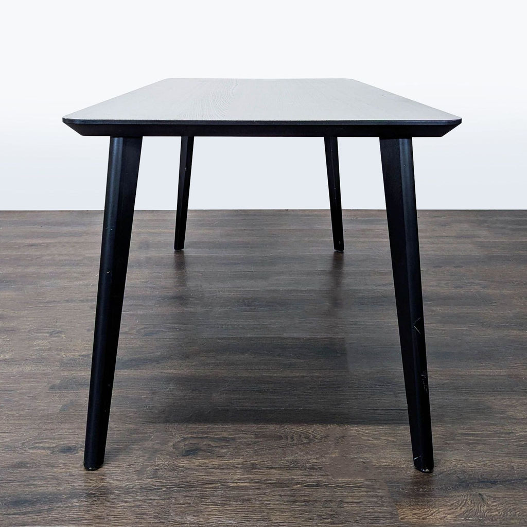 Dining table by Ikea, featuring a fiberboard core inspired by aircraft design and solid wood legs.