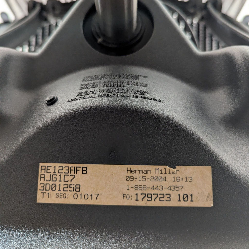 Side view of a Herman Miller Aeron chair, highlighting its breathable mesh back and modern design for office use.