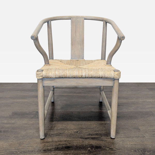 Elegant, handwoven Wishbone-style dining chair with curved backrest and wooden frame from West Elm.