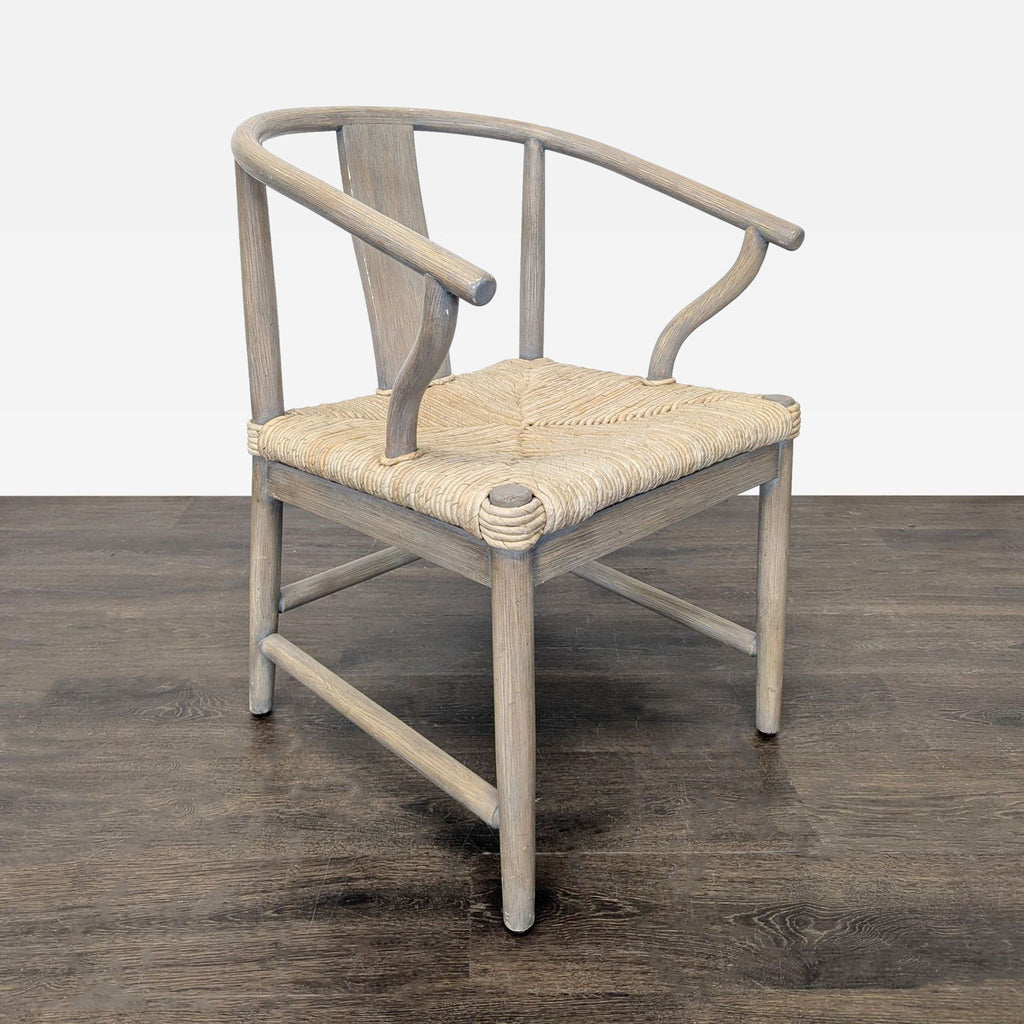 Compact West Elm Wishbone Chair featuring a light wood frame and intricately woven seat, ideal for dining.