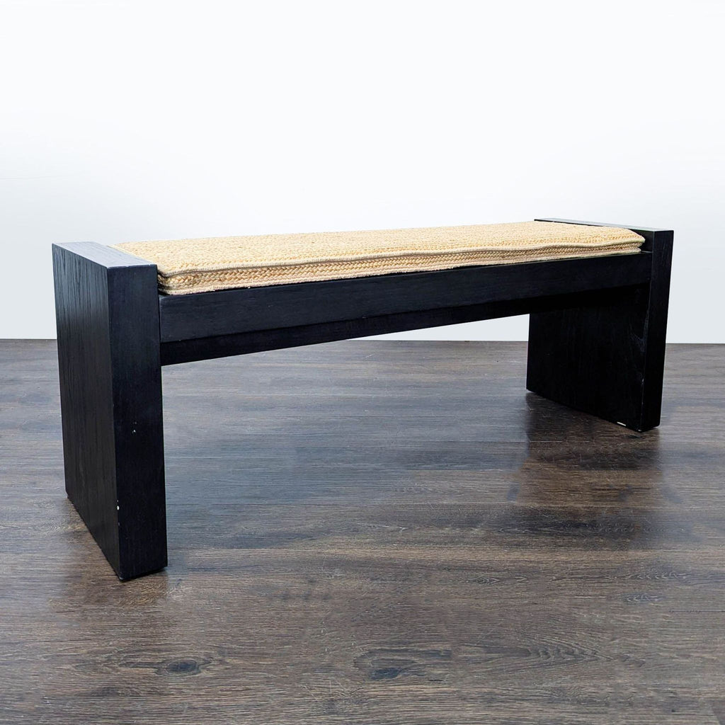 1. Modern West Elm bench with a dark wood frame and woven cushion, designed for contemporary interiors.