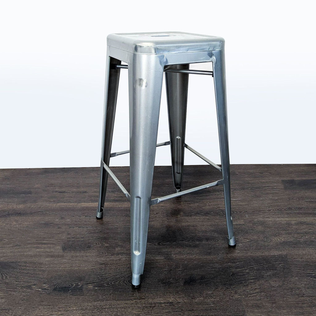 2. Industrial backless metal stool features an easy-to-clean raised seat with drain hole and sturdy footrest.  