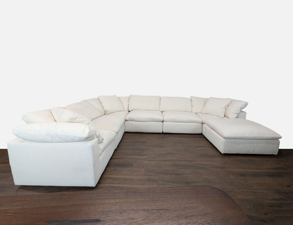 Restoration Hardware sectional sofa with white upholstery, deep cushions, and a large chaise for extra lounging.