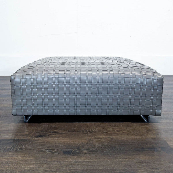 Modern woven leather ottoman with metal feet and padded frame, designed by Centro Studi Flexform in Italy.