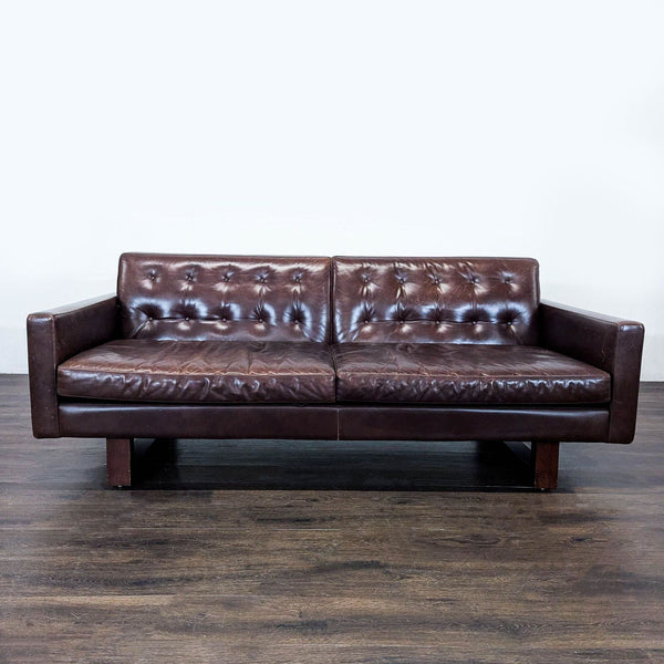 Room & Board Wells 3-seat sofa with brown tufted leather, wooden legs, and a modern, timeless design.