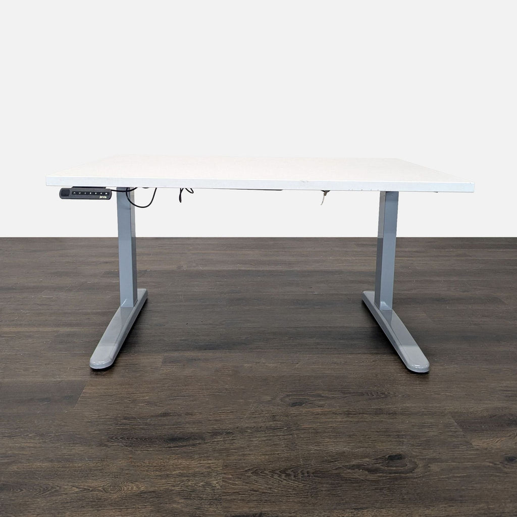 Jarvis electric height-adjustable desk with a white tabletop and easy-to-use control panel, ideal for office use.  