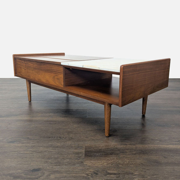 West Elm coffee table with walnut finish, marble accent, and a lift-top for versatile use.