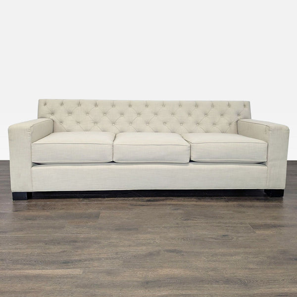 Modern beige 3-seat sofa with tufted backrest, square arms, and plush cushions, ideal for living areas.
