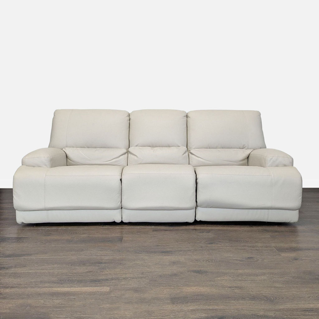 Modern Ikea 3-seat recliner sofa in soft cream leather, featuring plush cushioning and a clean, stylish design.
